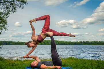 Young couple doing aerial yoga