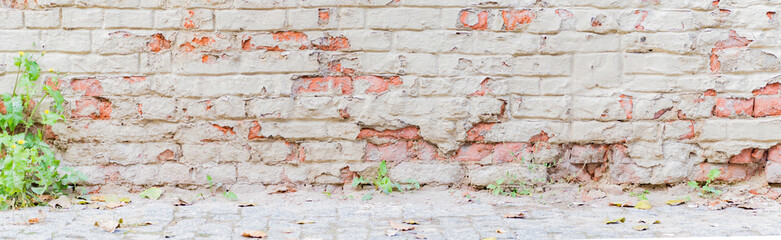 Panoramic scenery with red brick wall with peeling plaster