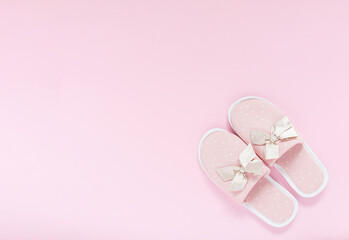 Pink home slippers on a pastel pink background. Top view. Copy space