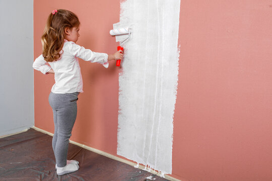father and daughter paint the wall in the room. home renovation
