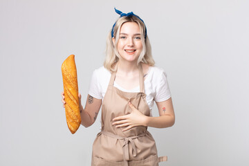 young pretty albino woman laughing out loud at some hilarious joke with a bread baguette