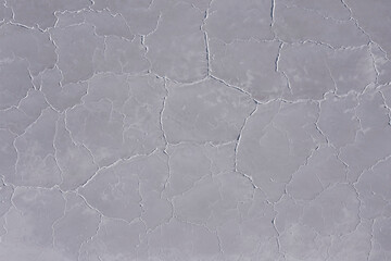 Abstract aerial view to the white pattern of a dry surface of a salt lake