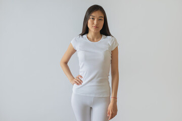 Attractive asian girl in white t-shirt and leggings. Mock-up.