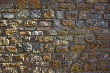 Texture lined with stone on the wall, of different shapes and shades for the whole frame