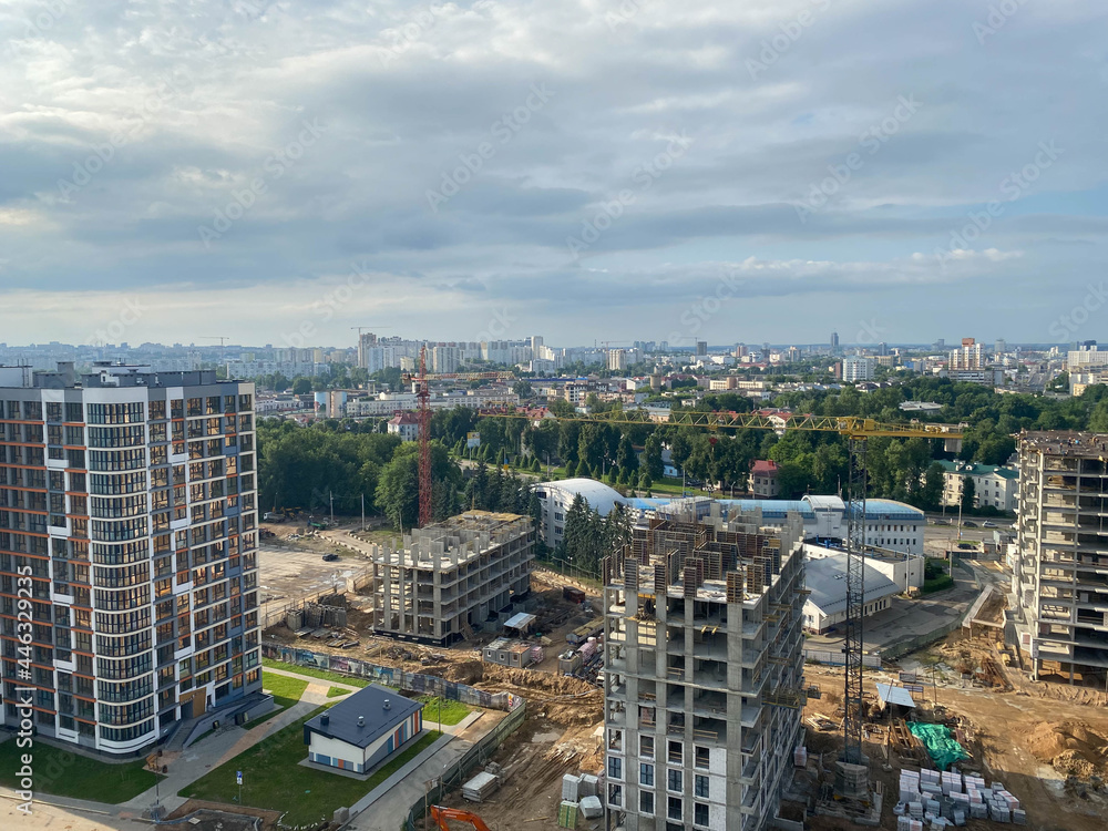 Poster a view from a height of a large modern construction site of tall large houses and multi-storey build