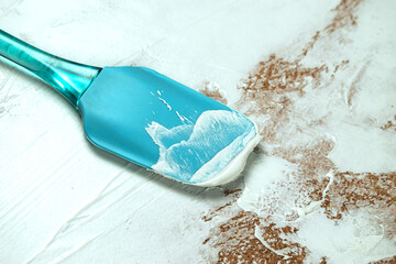 A man applies white plaster with a spatula