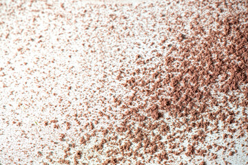 Loosed dry cosmetic pink background pigment. Top view of cracked blush, bronzer, powder or eye shadow cosmetic products. White background, selective focus