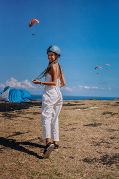 Woman skydriver with protective helmet in white clothing