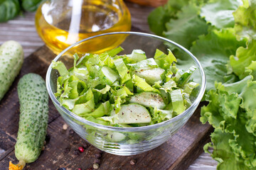 Healthy cabbage salad with cucumber, green onion and parsley on a plate
