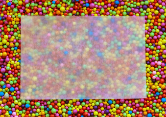 A beautiful blank white greeting mock up card with space for text on a colorful beads background. Rectangular frame. Matte translucent rectangular paper for writing congratulations. Jolly, fun concept