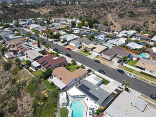 Fototapeta premium Aerial view of villas on the top of a valley and cliff with blue sky in San Diego County, California, USA