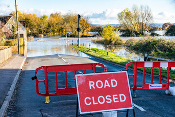 Floodwater from the River Severn closing the B4213 on the approach to Haw Bridge in the Severn Vale...