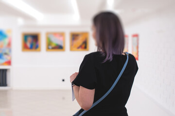 Group of visitors in pictures gallery opening, modern contemporary fine art collection exhibition, silhouettes of spectators standing in museum hall exposition with artwork paintings,  blurred image