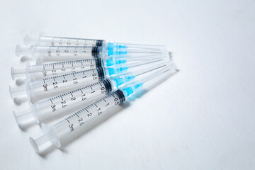 A hypodermic injection syringe. Syringes with blue needles. Medical Injectors. Copy space