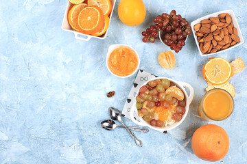 Fototapeta na wymiar Healthy breakfast, fruit salad with grapes, tangerines, banana and slimming jam. The concept of healthy and natural nutrition, detox diet, lifestyle, weight loss,