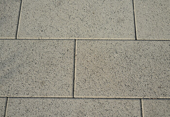 The texture of the tile in the form of rectangles of light gray color