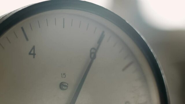 Old Pressure Gauges at the Factory. Manometer arrows move. Industrial barometer, close up view, vintage film look. Close-Up.