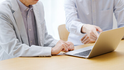 パソコンを教わるシニア男性