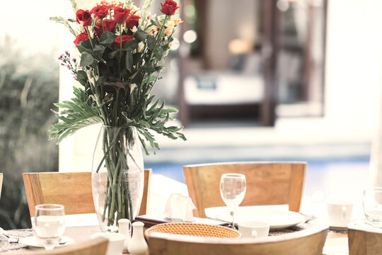 Flower bouquet at the table and pool in background
