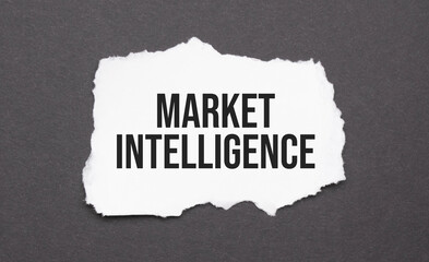 Market Intelligence sign on the torn paper on the black background