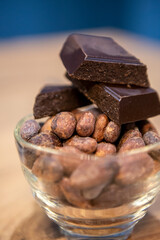 Cocoa beans and chocolate on a wooden table