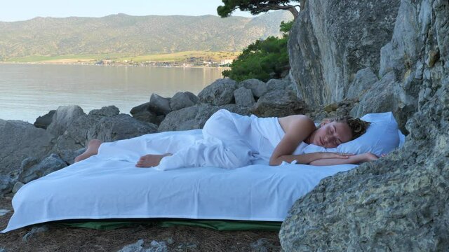 Sleeping woman rest on airbed with amazing nature view