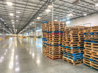 Massive Empty Industrial Warehouse Interior With Stacked Pallets