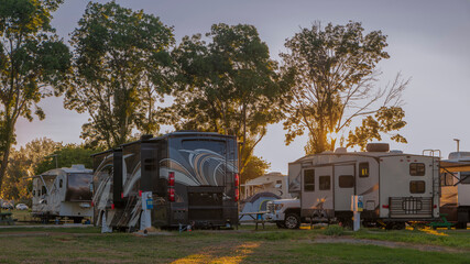 Camping in a Rv at a resort at sunset - obrazy, fototapety, plakaty