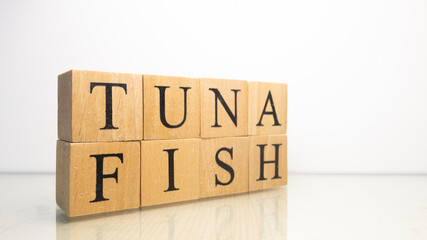 Tuna phrase created from wooden letter cubes. Seafood and food.