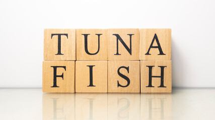 Tuna phrase created from wooden letter cubes. Seafood and food.