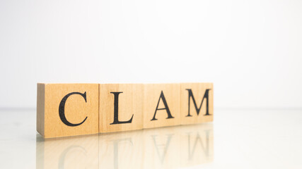 The name Clam was created from wooden letter cubes. Seafood and food.