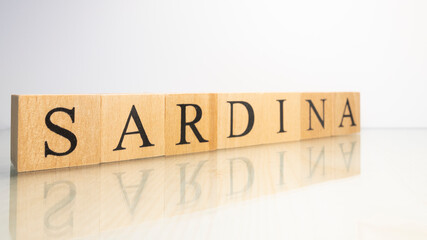 The name Sardina was created from wooden letter cubes. Seafood and food.