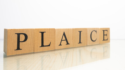 The name Plaice was created from wooden letter cubes. Seafood and food.