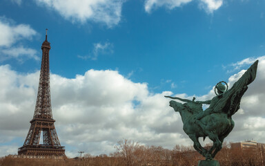 Eiffel tower panorama with la france renaissante statue horse sword selective focus