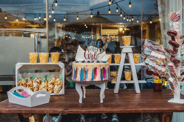 Gender reveal party cake snacks table selective focus