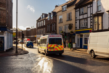 Ambulance van on road small city selective focus