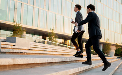 Businessmen young people go to the office to work in business suits holding coffee with them and...