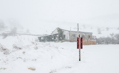Old mountain house under a snow storm in the Sierra de Urbasa.