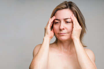 Upset older woman wants to prevent wrinkling