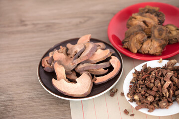 Chinese medicine papaya on a plate and other medicinal herbs
