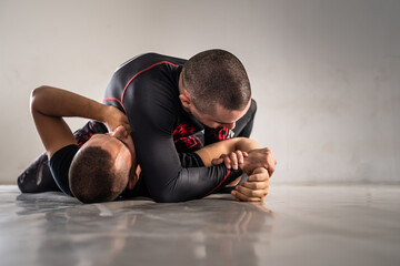 Brazilian jiu jistu bjj no-gi grappling training two male athletes drilling technique from mount...