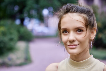 Brown eyed Caucasian woman 18 years old, close-up street portrait.