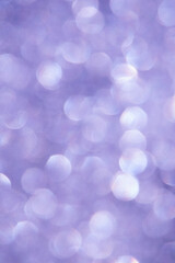 bright glitter background: bokeh effect from many colored lights on frozen glass, toning