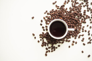 Espresso hot coffee in white cup with beans coffee on white table background. flat lay with copy space. caffeine drink breakfast in morning.