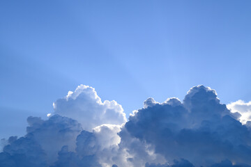 Blue sky with cumulus clouds and sunlight before sunset, Nature background