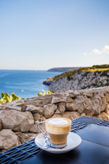 A cup of coffee with a view of the Salento coast line in southern Italy.