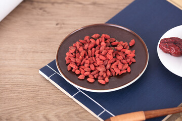 A plate of red medlar is on the medical book