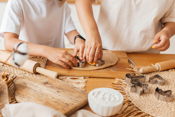 Mother and little daughter bake cookies and have fun in the kitchen. Homemade food. Happy loving family are preparing cookies together. Happy childhood