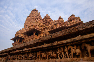 Side view of Laxman Temple western group, sculptures on the wall and beautiful sky pattern,...