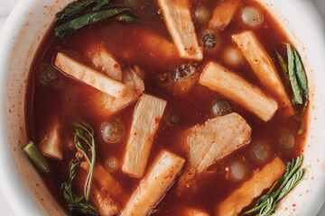 Thai Ryukyu Roe Sour Soup served in white bowl on white table.